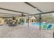 Expansive screened lanai with pool, hot tub, bar, and multiple seating areas overlooking yard at 4750 Rummell Rd, St Cloud, FL 34771