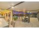 Extended, screened patio at dusk with pool, dining set, bar, and ambient string lights at 4750 Rummell Rd, St Cloud, FL 34771