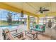 An outdoor covered patio features stylish furniture, a ceiling fan, and a view of the screened pool at 4750 Rummell Rd, St Cloud, FL 34771