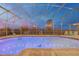 Evening view of a screened pool with outdoor seating and lights at 4750 Rummell Rd, St Cloud, FL 34771