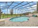 Exterior shot of screened pool area with open backyard, outdoor seating, and covered patio at 4750 Rummell Rd, St Cloud, FL 34771