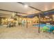 Dusk view of a screened in pool, outdoor seating, and covered patio with string lights at 4750 Rummell Rd, St Cloud, FL 34771