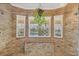 Custom stone shower with built in bench, rain shower head and natural light at 4750 Rummell Rd, St Cloud, FL 34771