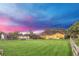 Dusk exterior shot of a home with a large yard with a screened pool and a detached garage at 4750 Rummell Rd, St Cloud, FL 34771