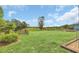 A spacious green lawn is enclosed by a wooden fence with mature trees in the background at 4750 Rummell Rd, St Cloud, FL 34771