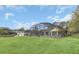 Exterior shot of a home with a large yard with a screened pool and a detached garage at 4750 Rummell Rd, St Cloud, FL 34771