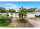 Quaint single-story home featuring a cozy front yard with a unique stone walkway and established greenery at 4908 Seminole Ave, Winter Park, FL 32792