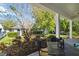 Relaxing covered patio with seating area, lush greenery, and serene outdoor space at 8677 Pinter St, Orlando, FL 32827