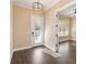 Elegant entryway with wood-look tile floors, modern light fixture, and a view into the adjacent room at 8677 Pinter St, Orlando, FL 32827