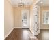 Elegant entryway with wood-look tile floors, modern light fixture, and a view into the adjacent room at 8677 Pinter St, Orlando, FL 32827