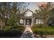 Charming two-story home with manicured lawn and inviting front porch under a colorful evening sky at 8677 Pinter St, Orlando, FL 32827