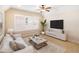 Cozy living area features comfortable seating, bright natural lighting, and a modern entertainment center at 8677 Pinter St, Orlando, FL 32827