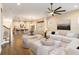 Open-concept living room with a modern ceiling fan that connects to the kitchen and dining area at 8677 Pinter St, Orlando, FL 32827
