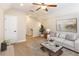 Cozy living room featuring neutral tones, comfortable seating, and a decorative rug at 8677 Pinter St, Orlando, FL 32827