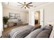 Comfortable bedroom with a calming color palette, stylish furniture, and an open doorway to the bathroom at 8677 Pinter St, Orlando, FL 32827