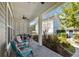 Cozy covered patio with outdoor furniture, ceiling fan, and a view of the lush backyard at 8677 Pinter St, Orlando, FL 32827