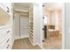 Well-organized walk-in closet with custom shelves, drawers, and access to the primary bathroom at 8677 Pinter St, Orlando, FL 32827