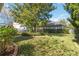 Tranquil backyard with a green lawn, trimmed bushes, and a view of the neighboring houses at 8677 Pinter St, Orlando, FL 32827