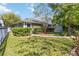 Lush lawn and garden featuring neatly trimmed hedges, a privacy fence, and verdant trees at 8677 Pinter St, Orlando, FL 32827