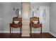 Charming bathroom featuring dual vessel sinks, dark wood cabinets, vintage faucets, and a central linen tower at 205 N Village St, Celebration, FL 34747