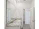 Double vanity bathroom with granite countertop and large mirror at 2149 Rosewood Dr, Bartow, FL 33830