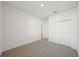 Well-lit bedroom with neutral carpeting and double-door closet at 2149 Rosewood Dr, Bartow, FL 33830