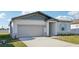 Curb appeal abounds in this one-story home featuring a gray exterior and a landscaped front yard at 2149 Rosewood Dr, Bartow, FL 33830