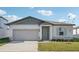 One-story home with gray siding, light green door, and landscaped lawn at 2149 Rosewood Dr, Bartow, FL 33830