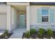 Inviting front entrance with light green door and stone accents at 2149 Rosewood Dr, Bartow, FL 33830