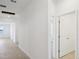 A long hallway with light neutral walls and tile flooring at 2149 Rosewood Dr, Bartow, FL 33830