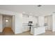 Open concept kitchen boasts white cabinets and an island at 2149 Rosewood Dr, Bartow, FL 33830