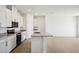Modern kitchen with white cabinets, granite countertops, and stainless steel appliances at 2149 Rosewood Dr, Bartow, FL 33830
