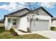 Two-story house with gray and white exterior, landscaping, and two-car garage at 2758 Virginia Pine Dr, Bartow, FL 33830