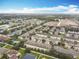 Community aerial view shows attached homes with a pool, trees and green space on a sunny day at 3529 Sanctuary Dr, Saint Cloud, FL 34769