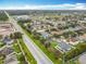 Community aerial view shows lush green spaces, well-maintained homes and convenient road access on a sunny day at 3529 Sanctuary Dr, St Cloud, FL 34769
