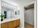 Well-lit bathroom features a large mirror, vanity with sink, and tiled floors at 3529 Sanctuary Dr, St Cloud, FL 34769