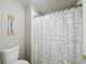 Cozy bathroom featuring a toilet and shower-tub with a seashell-themed curtain at 3529 Sanctuary Dr, St Cloud, FL 34769