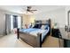 Bright bedroom showcases a ceiling fan, soft carpet, and large window at 3529 Sanctuary Dr, St Cloud, FL 34769