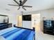 Spacious bedroom with sleek furniture, ceiling fan, and multiple rooms accessible from doorway at 3529 Sanctuary Dr, St Cloud, FL 34769