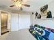 View of bedroom with large closet, carpeted floors, and fun, unique Batman decorations at 3529 Sanctuary Dr, St Cloud, FL 34769
