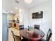 Open concept eat-in kitchen with wood dining table, leather chairs and a wall-mounted television at 3529 Sanctuary Dr, St Cloud, FL 34769