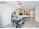 Open concept dining area with view into kitchen, breakfast bar and modern light fixture at 3529 Sanctuary Dr, St Cloud, FL 34769