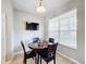 Eat-in kitchen dining area featuring a wood table, leather chairs, and a window for natural light at 3529 Sanctuary Dr, St Cloud, FL 34769