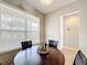 Bright dining area with a wood table, four chairs, and a window for natural light with tiled floor at 3529 Sanctuary Dr, St Cloud, FL 34769