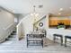 Open-concept dining area boasts stylish furnishings, with a staircase leading to the upper level at 3529 Sanctuary Dr, St Cloud, FL 34769