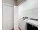 Bright laundry room featuring a Whirlpool washer and dryer, wire shelving, and a bi-fold door at 3529 Sanctuary Dr, St Cloud, FL 34769