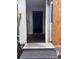 Exterior entryway featuring a small porch with steps leading into a home under renovation and a boarded window at 1805 W 15Th St # 1/2, Sanford, FL 32771