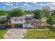 Aerial view of a home showcasing its large yard, driveway, and neighborhood at 2201 Delaney. Ave, Orlando, FL 32806