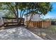 Backyard with wooden deck, mature trees, and privacy fence at 2201 Delaney. Ave, Orlando, FL 32806