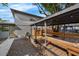 Spacious backyard with gazebo, wooden benches, and gray exterior walls at 2201 Delaney. Ave, Orlando, FL 32806
